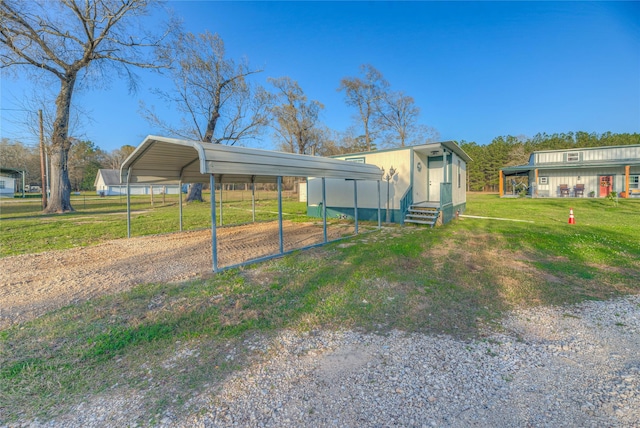 exterior space with a carport, driveway, and entry steps