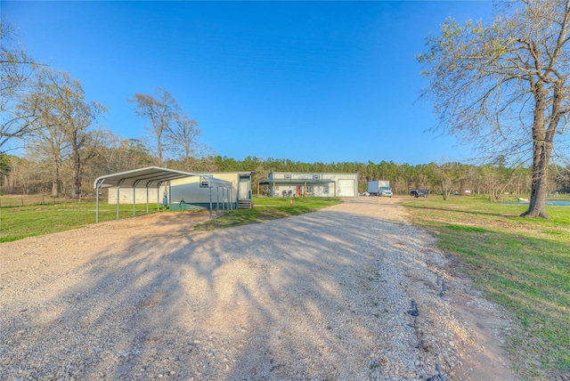 manufactured / mobile home featuring a garage, a front lawn, and driveway