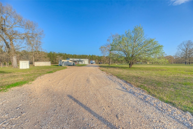 view of road with gravel driveway