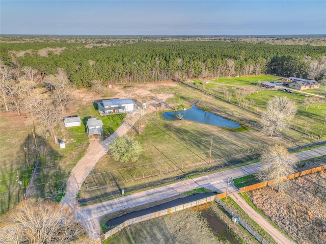 aerial view with a forest view, a water view, and a rural view