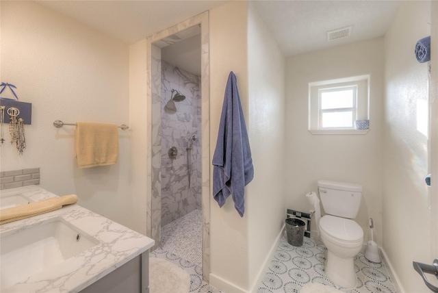 bathroom featuring visible vents, toilet, baseboards, walk in shower, and vanity