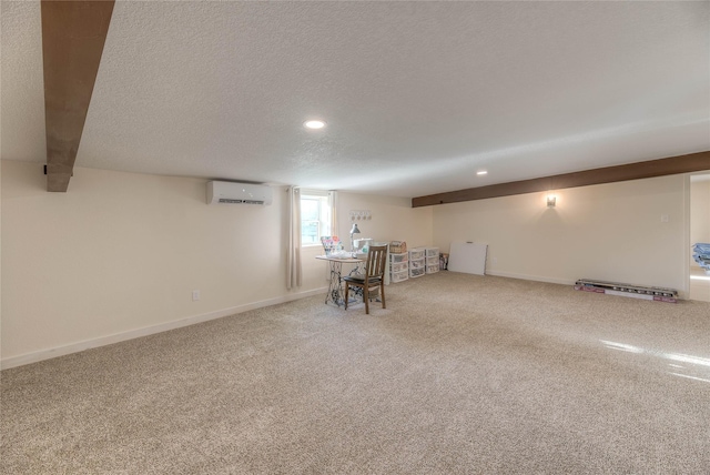 below grade area with baseboards, carpet flooring, a textured ceiling, and a wall unit AC