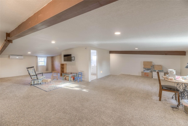 game room featuring carpet flooring, a textured ceiling, and a wall unit AC