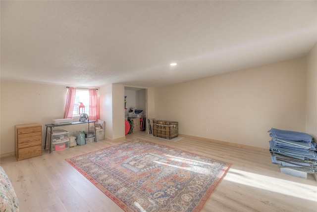 sitting room with recessed lighting, baseboards, and wood finished floors