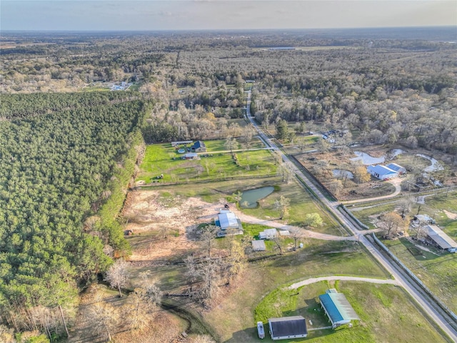 drone / aerial view featuring a wooded view