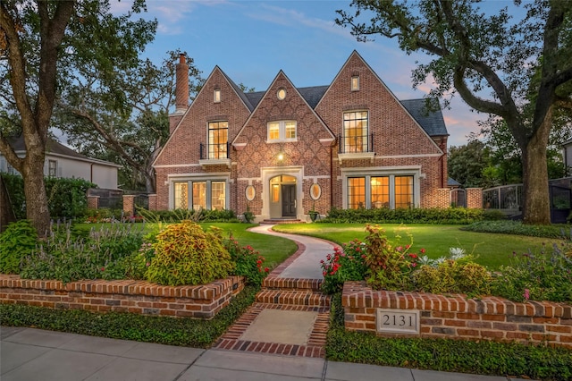 2131 Brentwood Dr, Houston, TX 77019 - tudor-style house with a chimney and brick siding