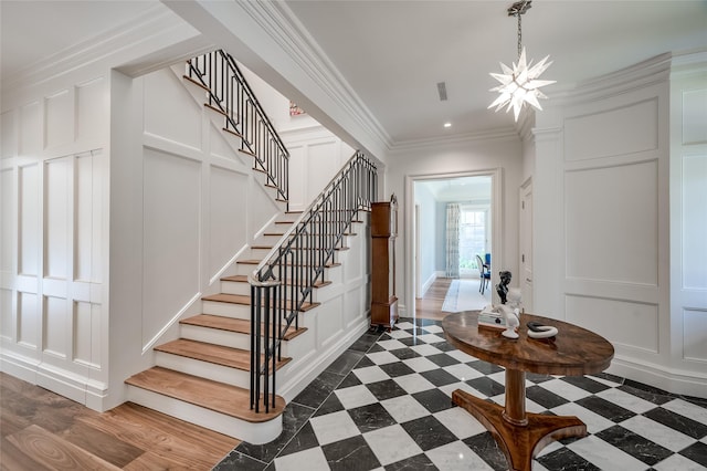 2131 Brentwood Dr, Houston, TX 77019 - entryway featuring a decorative wall, stairs, a chandelier, ornamental molding, and recessed lighting