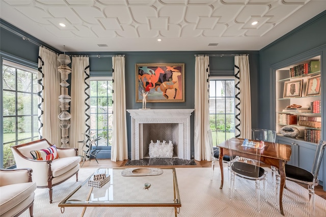 2131 Brentwood Dr, Houston, TX 77019 - living room with plenty of natural light, a fireplace with flush hearth, ornamental molding, and wood finished floors
