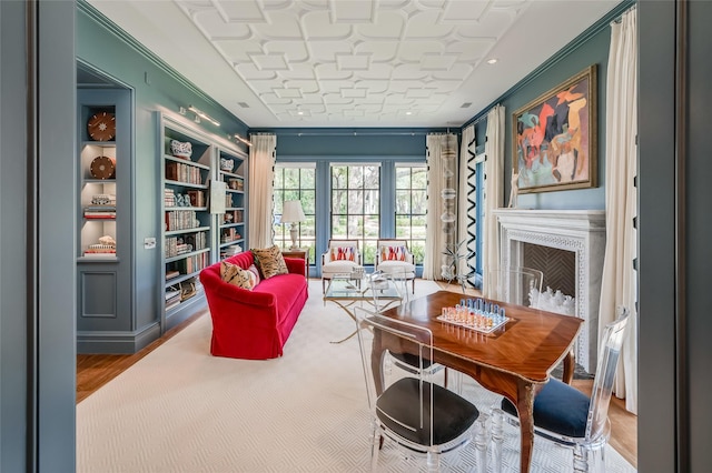 2131 Brentwood Dr, Houston, TX 77019 - living area with crown molding, a fireplace, wood finished floors, and built in shelves