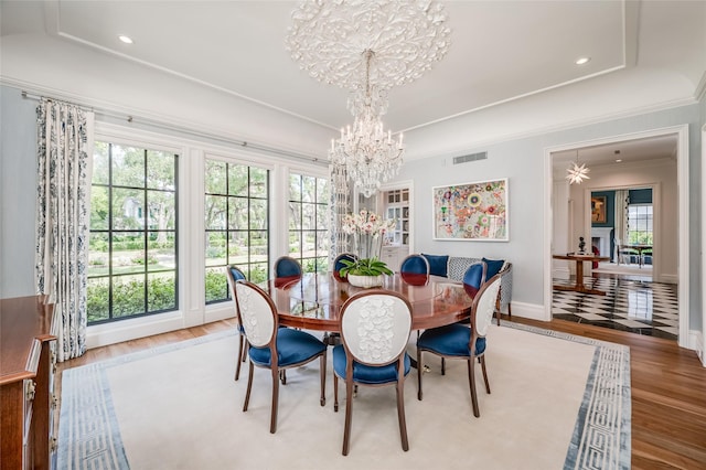 2131 Brentwood Dr, Houston, TX 77019 - dining area with a chandelier, wood finished floors, plenty of natural light, ornamental molding, and recessed lighting