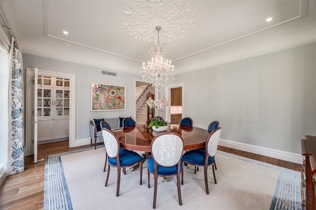 2131 Brentwood Dr, Houston, TX 77019 - dining space with a chandelier, light wood finished floors, stairs, baseboards, and recessed lighting