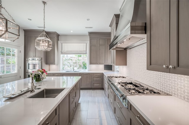 2131 Brentwood Dr, Houston, TX 77019 - kitchen with wall chimney range hood, a sink, plenty of natural light, and recessed lighting