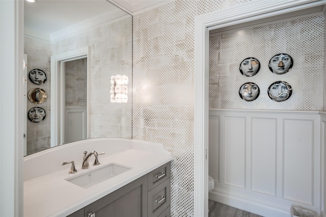 2131 Brentwood Dr, Houston, TX 77019 - bathroom featuring ornamental molding, toilet, a decorative wall, and vanity