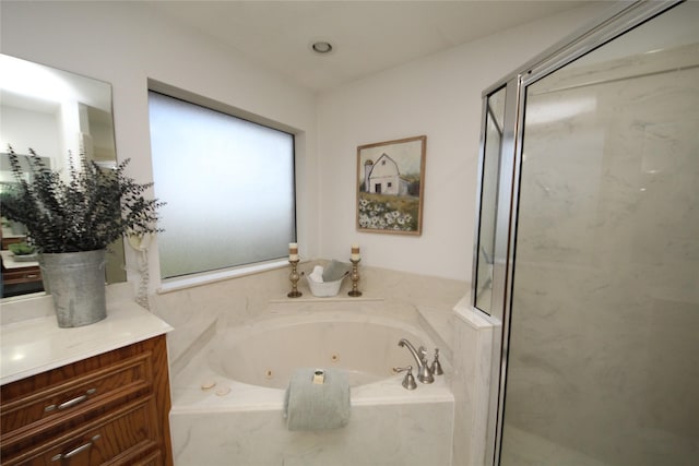 bathroom with vanity, a whirlpool tub, and a marble finish shower