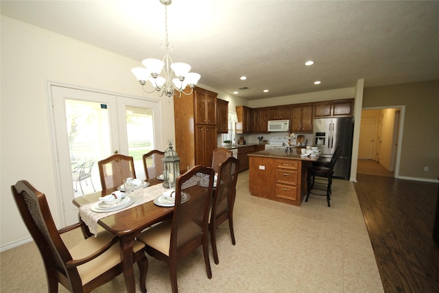 dining room featuring light floors, baseboards, a chandelier, and recessed lighting