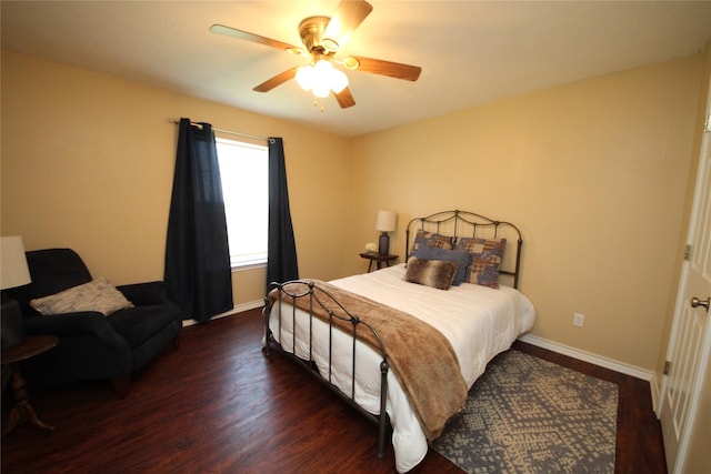 bedroom with a ceiling fan, baseboards, and wood finished floors