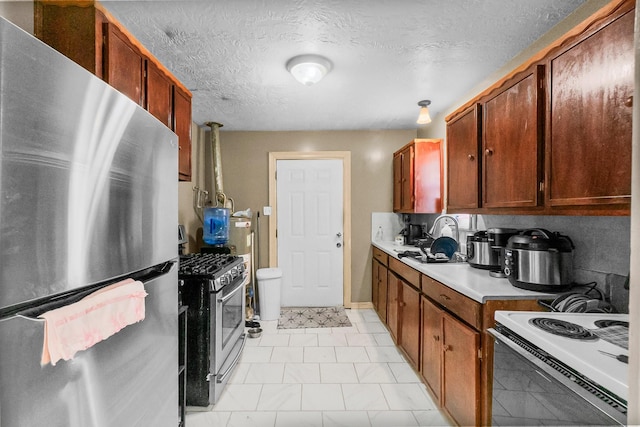 2105 Russell St, Houston, TX 77026 - kitchen with a textured ceiling, stainless steel appliances, and light countertops