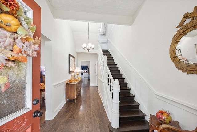 725 Columbus Rd, Sealy, TX 77474 - foyer featuring lofted ceiling with beams, dark wood-style flooring, stairs, wainscoting, and a notable chandelier