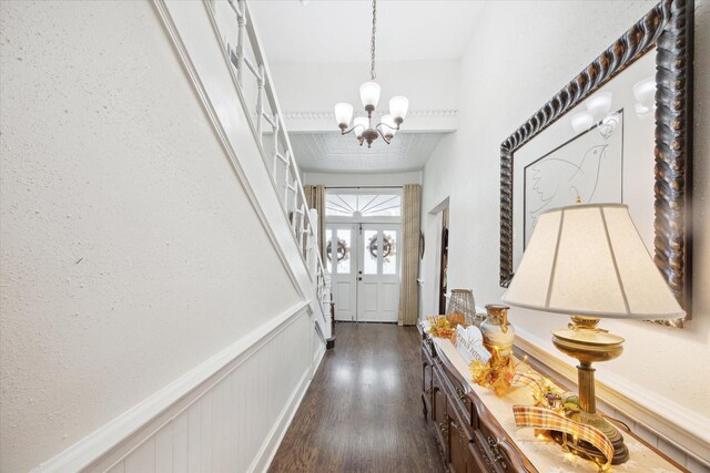 725 Columbus Rd, Sealy, TX 77474 - doorway featuring a chandelier, dark wood-style floors, wainscoting, and a decorative wall