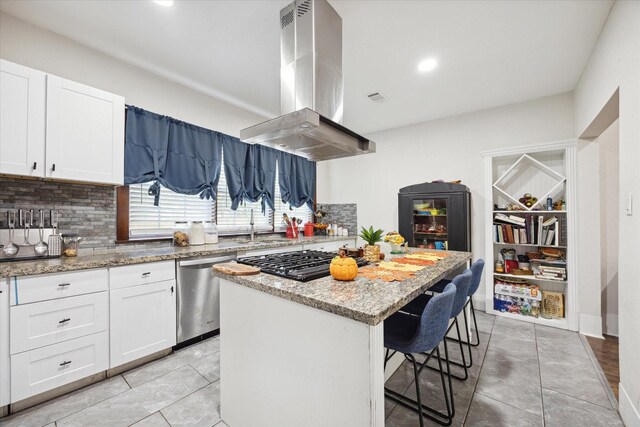 725 Columbus Rd, Sealy, TX 77474 - kitchen featuring a kitchen bar, black gas cooktop, a kitchen island, stainless steel dishwasher, and island range hood