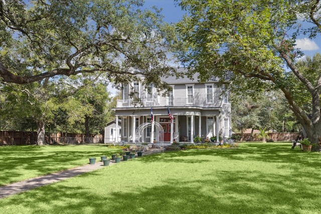725 Columbus Rd, Sealy, TX 77474 - back of house featuring covered porch, a lawn, and fence