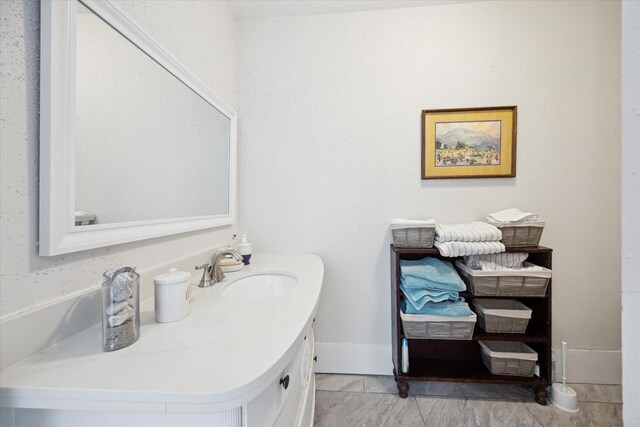 725 Columbus Rd, Sealy, TX 77474 - bathroom with vanity, baseboards, and marble finish floor