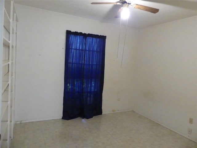 empty room featuring tile patterned floors and ceiling fan