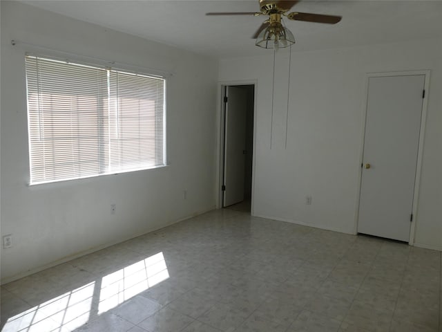 spare room with a ceiling fan