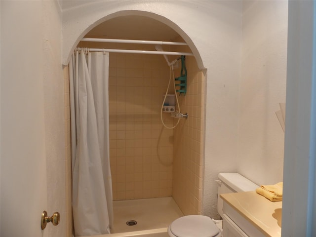 full bath with a shower stall, toilet, and vanity