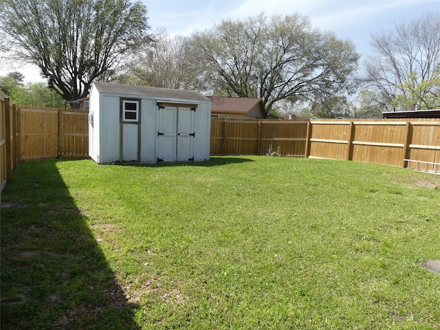 view of yard featuring a storage shed, an outdoor structure, and a fenced backyard