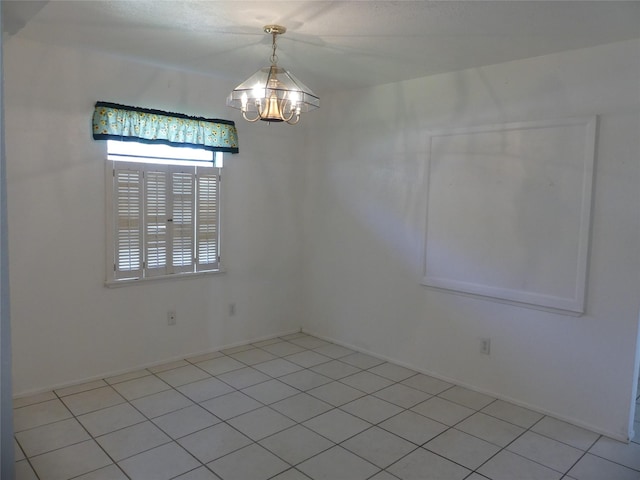 unfurnished room featuring light tile patterned floors and a chandelier