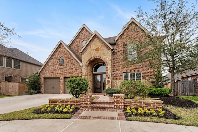 17131 Lumberton Dr, Cypress, TX 77433 - traditional-style house featuring concrete driveway, fence, brick siding, and stone siding