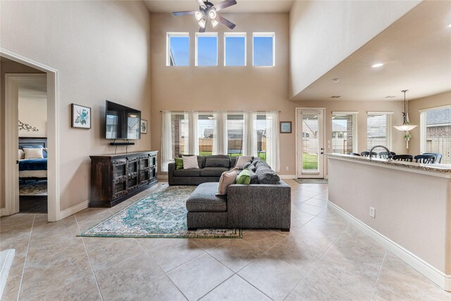 17131 Lumberton Dr, Cypress, TX 77433 - living area featuring ceiling fan, light tile patterned flooring, a high ceiling, and baseboards