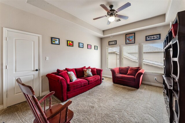 17131 Lumberton Dr, Cypress, TX 77433 - living room featuring a raised ceiling, carpet, a ceiling fan, and baseboards