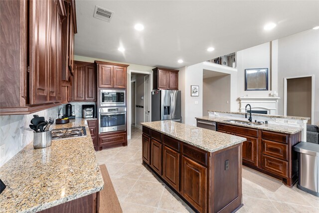 17131 Lumberton Dr, Cypress, TX 77433 - kitchen featuring stainless steel appliances, a sink, a center island, light stone countertops, and recessed lighting