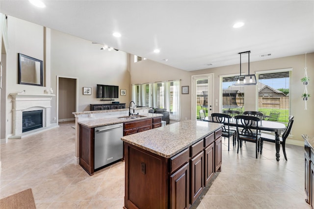 17131 Lumberton Dr, Cypress, TX 77433 - kitchen with stainless steel dishwasher, a kitchen island with sink, open floor plan, light stone counters, and a sink