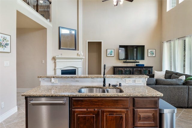 17131 Lumberton Dr, Cypress, TX 77433 - kitchen featuring dishwasher, a towering ceiling, a sink, open floor plan, and light tile patterned floors