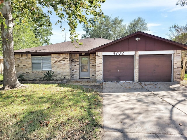 ranch-style house featuring an attached garage, brick siding, concrete driveway, a front lawn, and board and batten siding