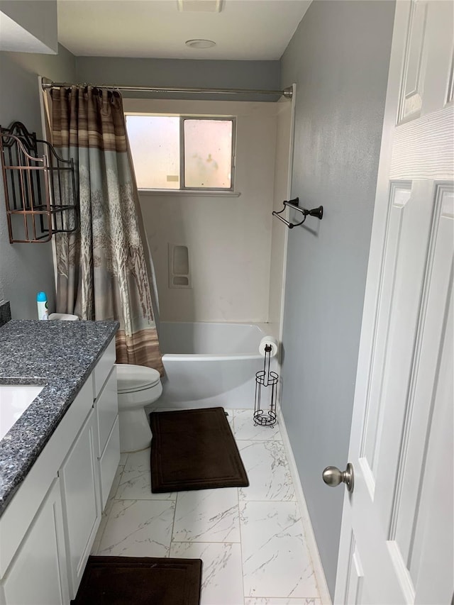 full bath featuring baseboards, toilet, shower / tub combo, marble finish floor, and vanity