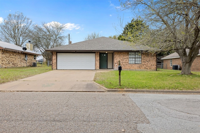 view of front of house with central air condition unit, driveway, a front yard, a garage, and brick siding