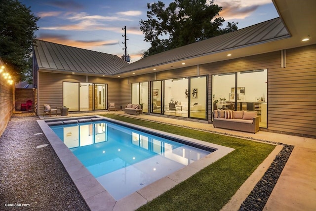 1035 Rutland St, Houston, TX 77008 - pool at dusk with an outdoor hangout area, an outdoor pool, a fenced backyard, and a patio