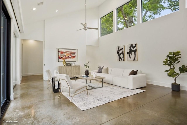 1035 Rutland St, Houston, TX 77008 - living area featuring concrete flooring, a towering ceiling, a ceiling fan, baseboards, and recessed lighting