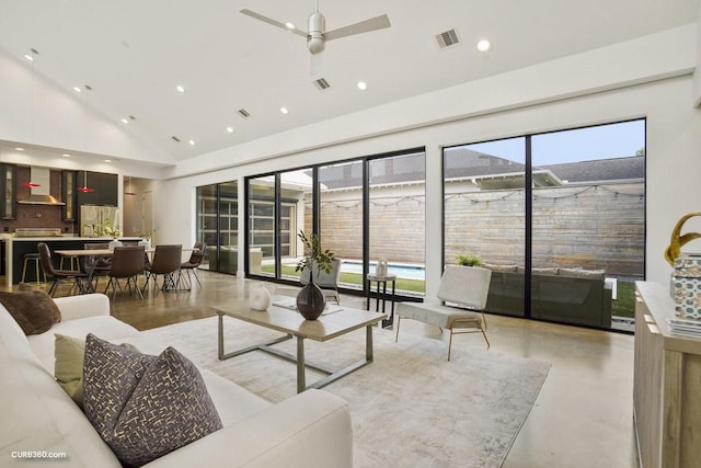 1035 Rutland St, Houston, TX 77008 - living room featuring high vaulted ceiling, recessed lighting, a ceiling fan, plenty of natural light, and finished concrete floors