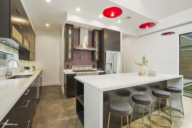 1035 Rutland St, Houston, TX 77008 - kitchen featuring high end refrigerator, wall chimney exhaust hood, a sink, concrete flooring, and light countertops