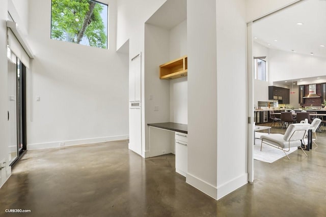 1035 Rutland St, Houston, TX 77008 - hallway with a high ceiling, concrete flooring, baseboards, and recessed lighting