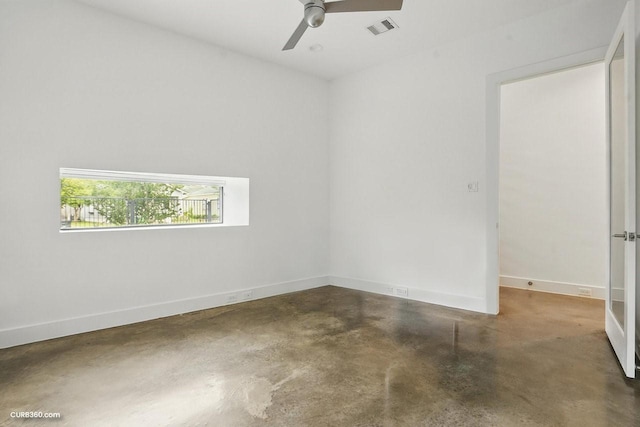 1035 Rutland St, Houston, TX 77008 - spare room featuring concrete floors, baseboards, and ceiling fan