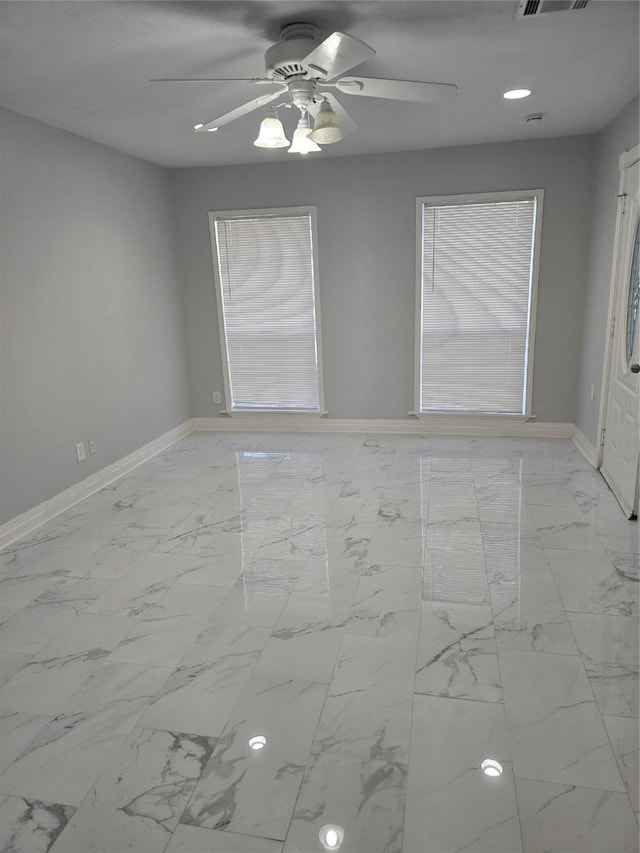 unfurnished room featuring baseboards, a ceiling fan, marble finish flooring, and recessed lighting