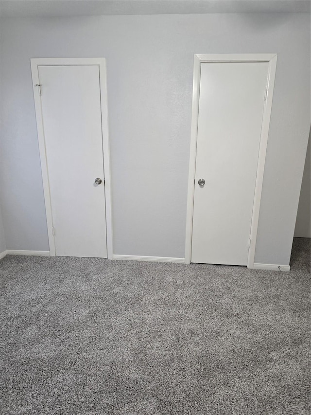 unfurnished bedroom with carpet and baseboards