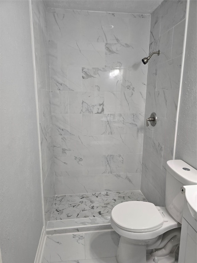 full bathroom with toilet, a shower stall, marble finish flooring, and vanity