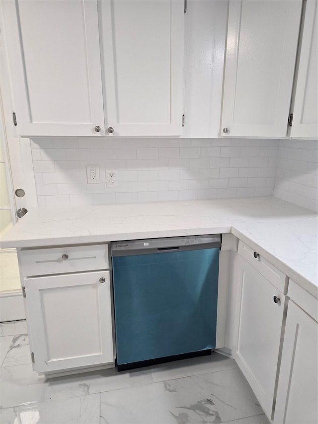 kitchen with dishwasher, light marble finish flooring, white cabinetry, light stone counters, and backsplash